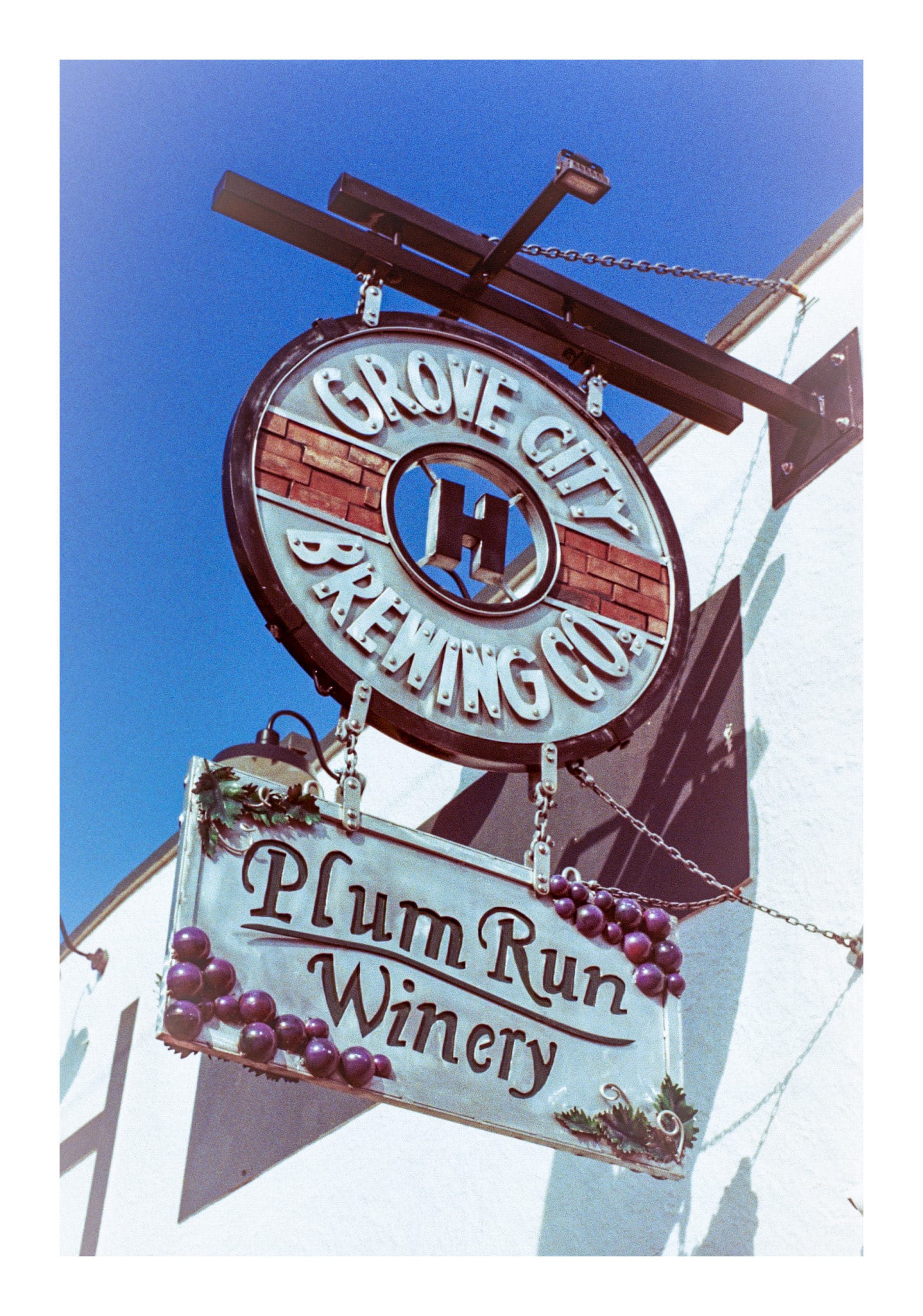 Film photo of a hanging sign of Grove city Brewing Co's Plum Run Winery