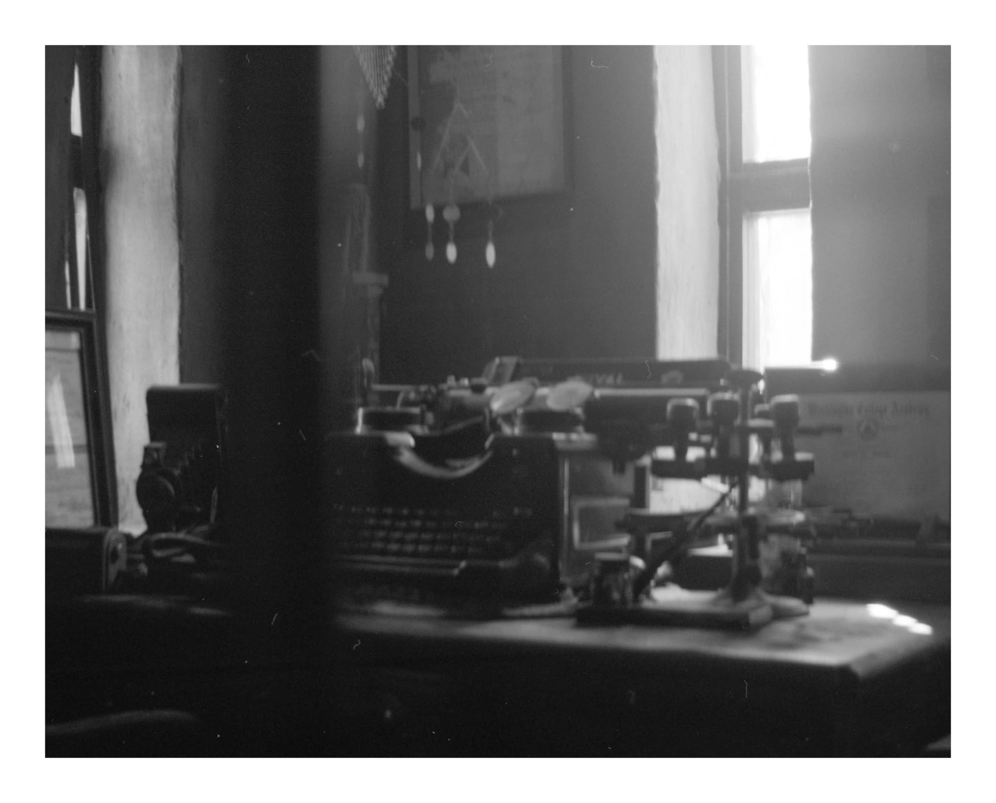 Film photo using 120 film with a Brownie Film camera, featuring an old office desk with a vintage folding camera, typewriter and office equipment next to it