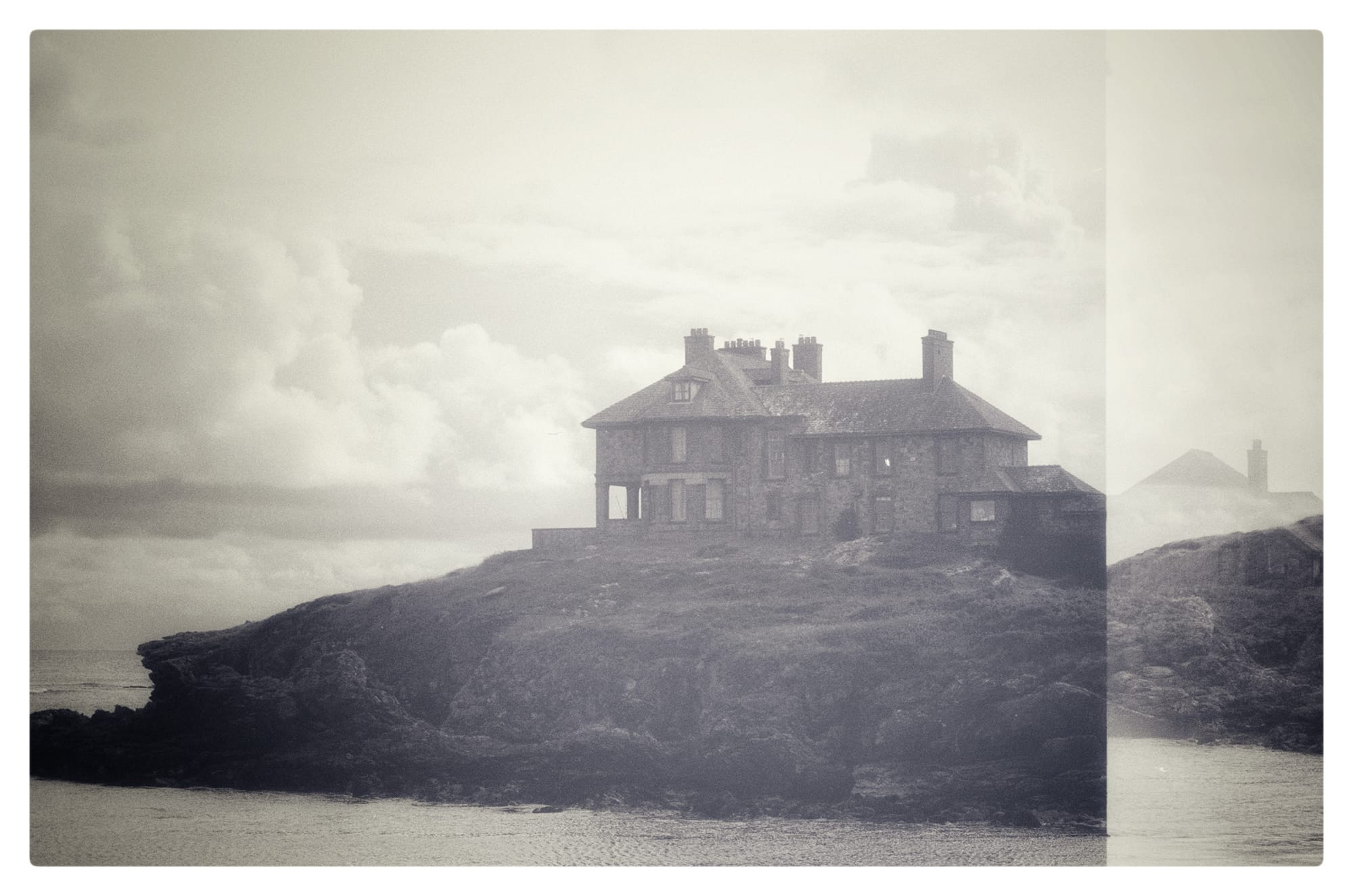 Black and white film picture of a sea-side manor in Anglesey