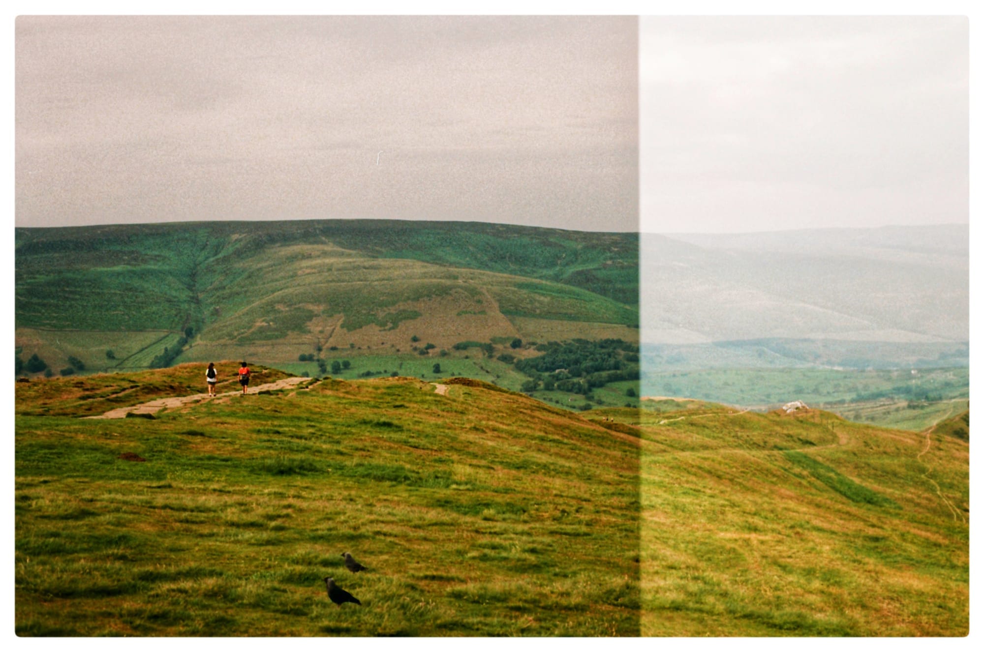 Color film picture of two people walking down the steps at Mam Tor with some of the image slightly more exposed than the other side.