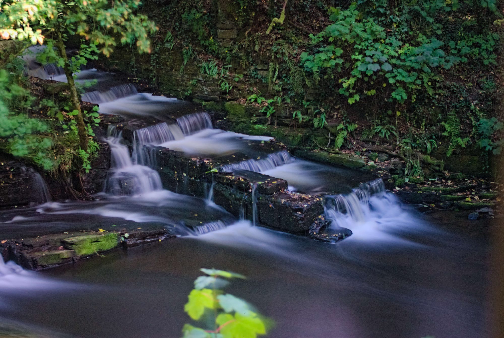Long exposure shot of the side of the weir's overflow steps